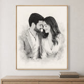 Custom couple portrait sketch on canvas in a Natural Walnut frame displayed above a light wood cabinet.