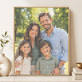Custom mosaic dots photo wall art in a natural wood frame displayed on a neutral home decor shelf